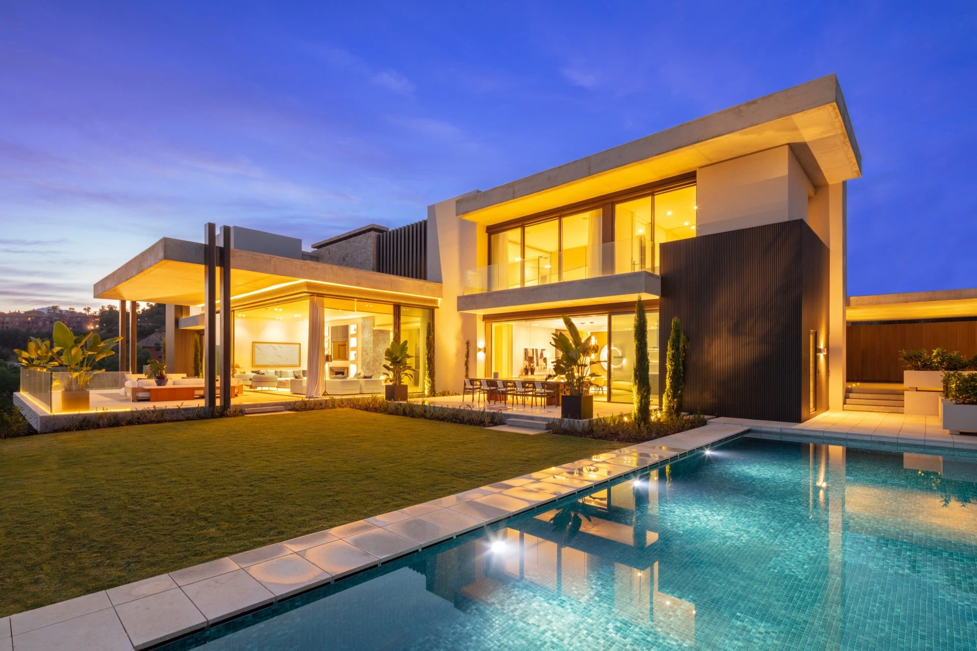 Contemporary La Quinta villa illuminated beside the private pool at dusk