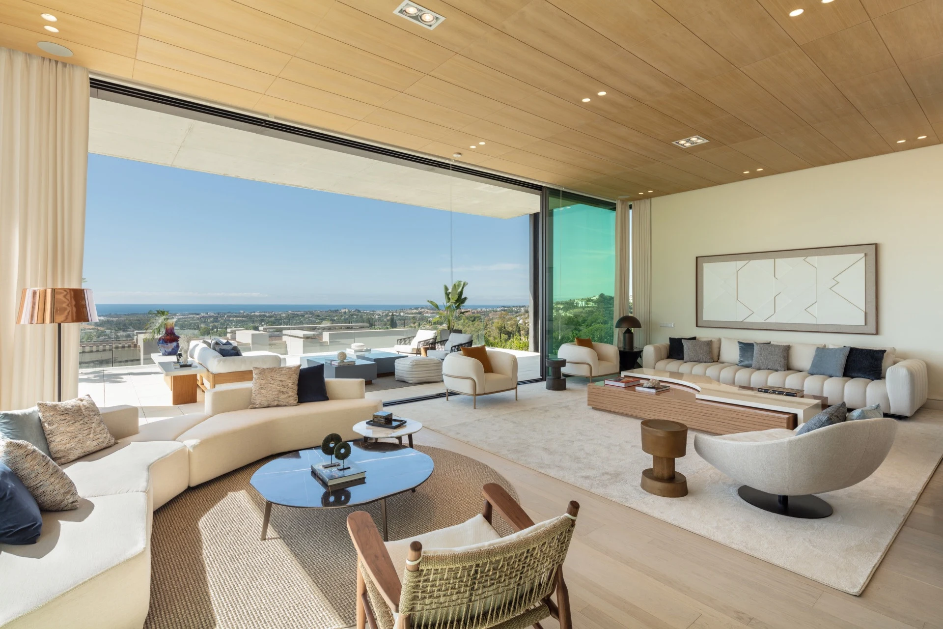 Open living area with sea views and sliding glass walls in La Quinta