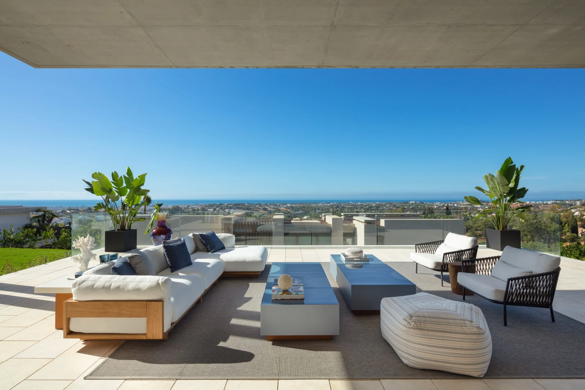 Covered lounge terrace overlooking the Mediterranean coastline