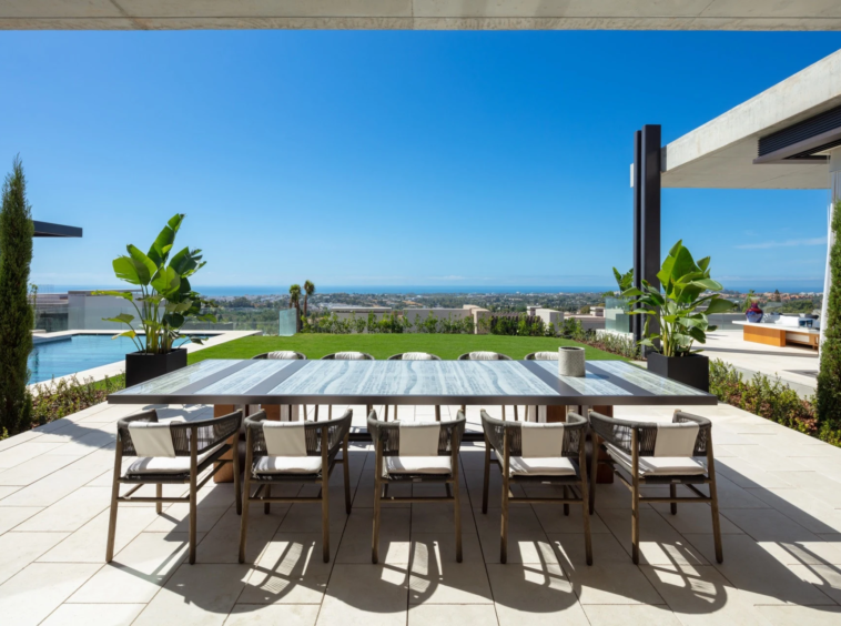Outdoor dining terrace facing the garden and sea
