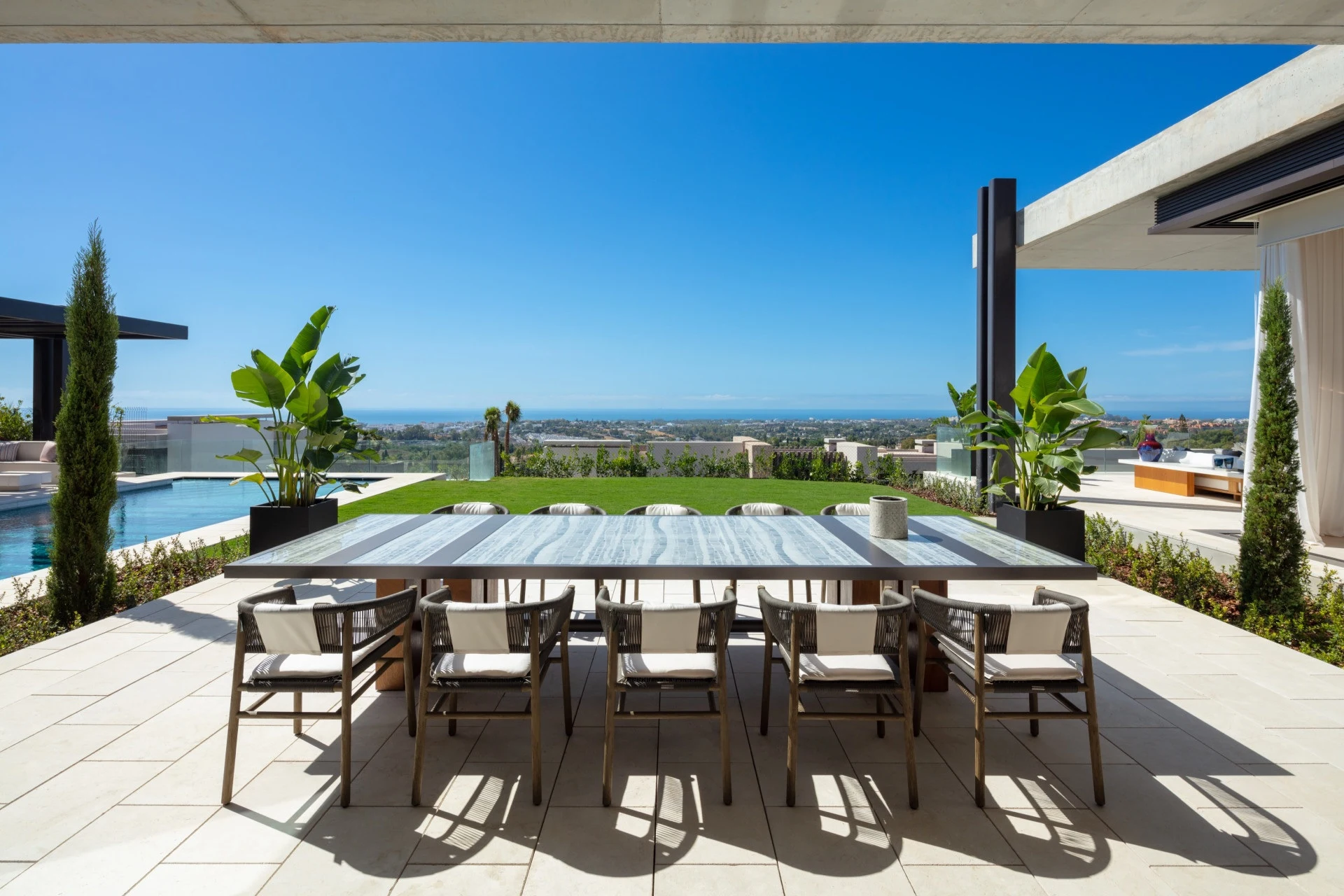 Outdoor dining terrace facing the garden and sea