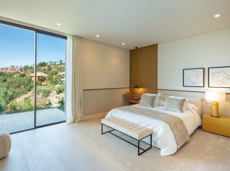 Guest bedroom with corner windows overlooking the hills