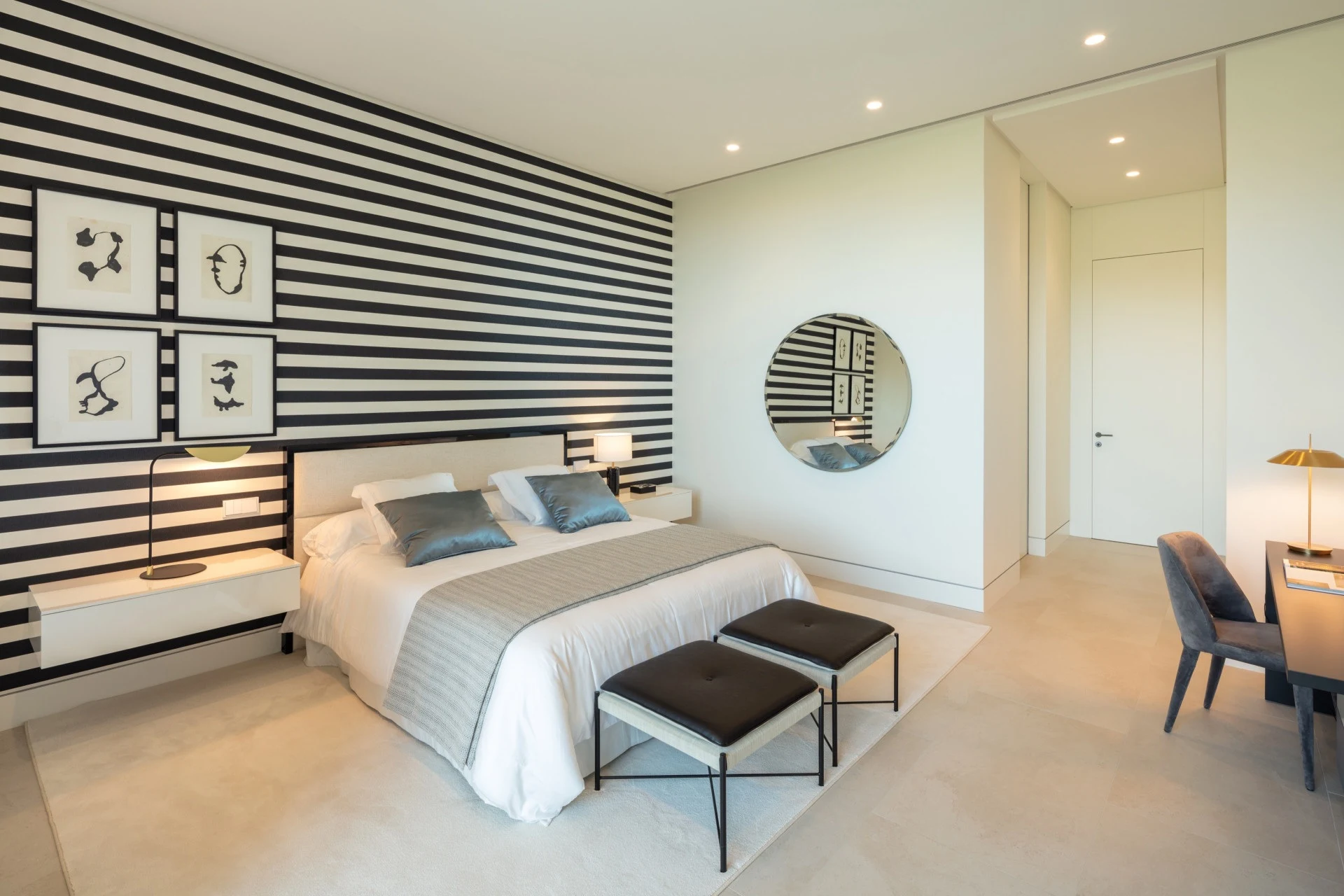 Bedroom with striped wall detailing and a writing desk