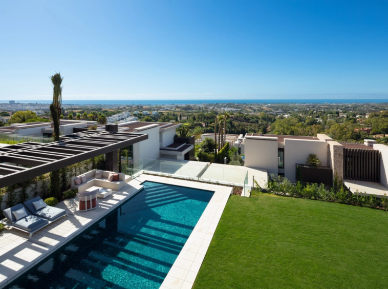 Elevated view of the private pool, lawn and Mediterranean coast