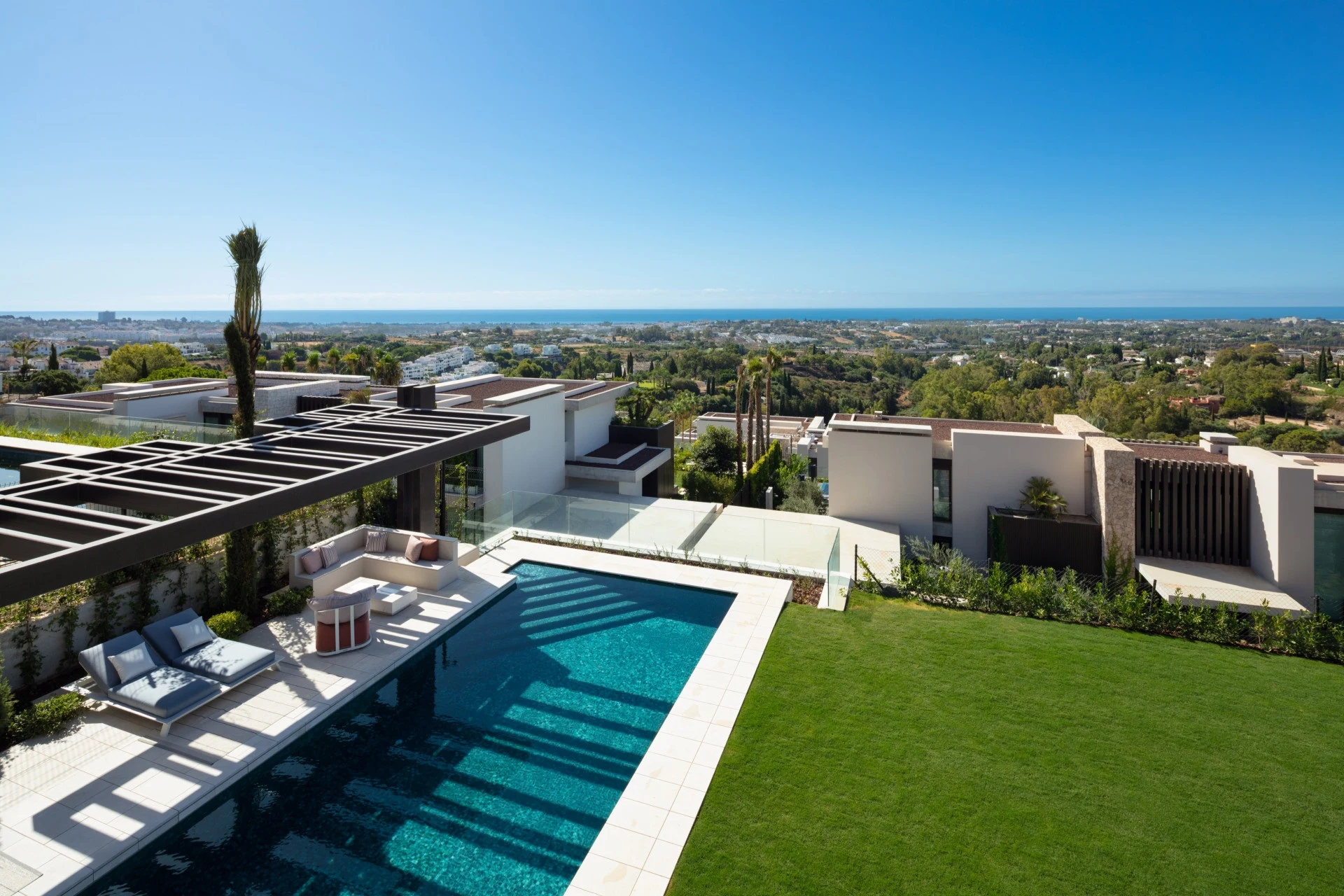 Elevated view of the private pool, lawn and Mediterranean coast