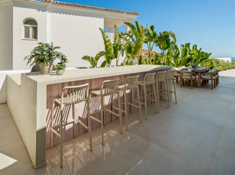 Outdoor bar with seating beside the dining terrace