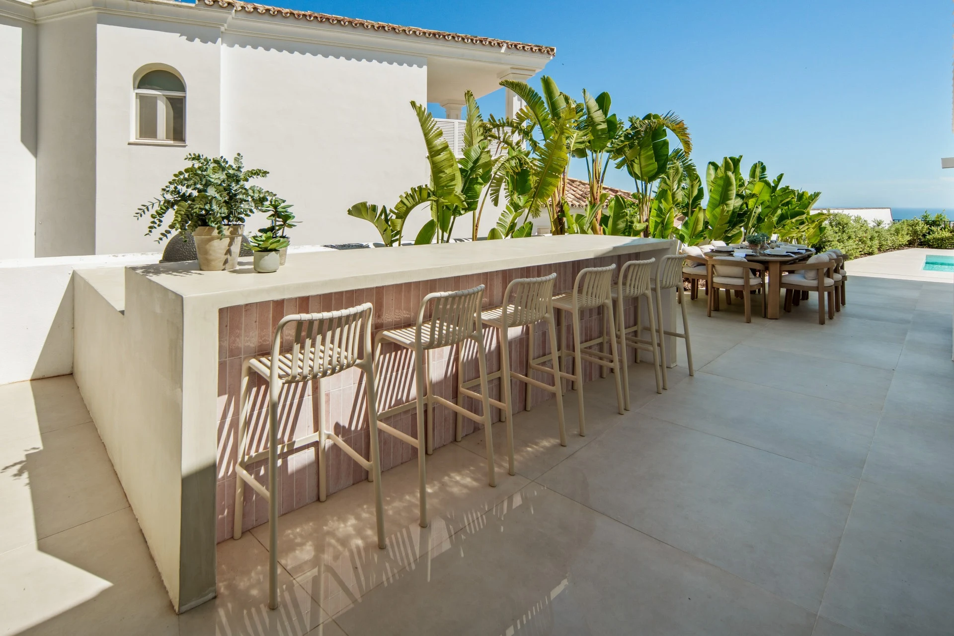 Outdoor bar with seating beside the dining terrace