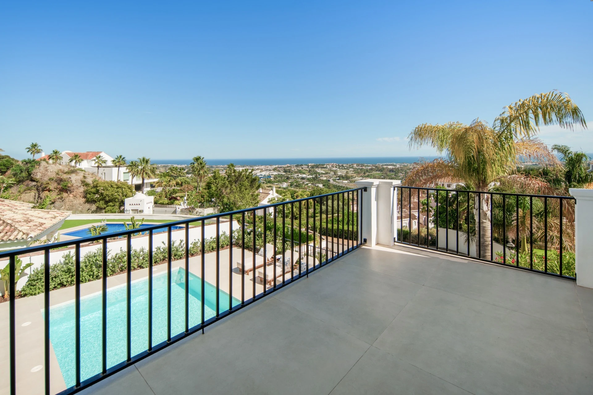 Private balcony overlooking the pool and coastline