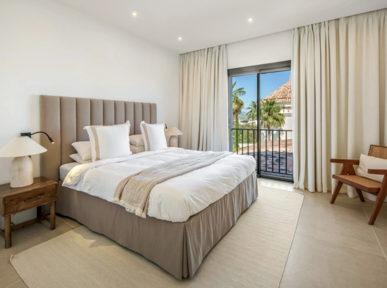 Upper-floor bedroom with full-height balcony doors