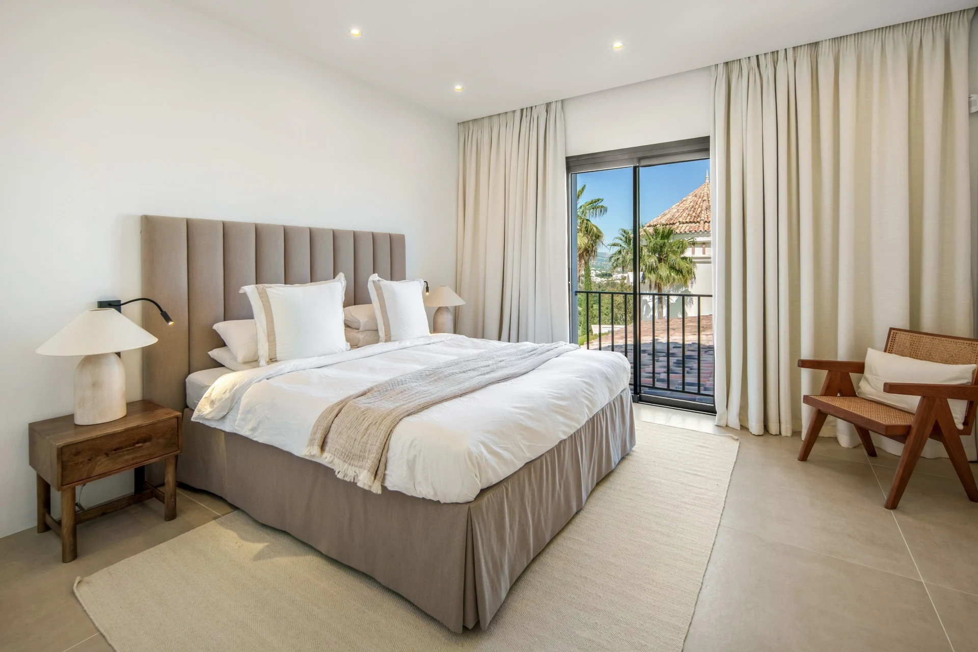Upper-floor bedroom with full-height balcony doors