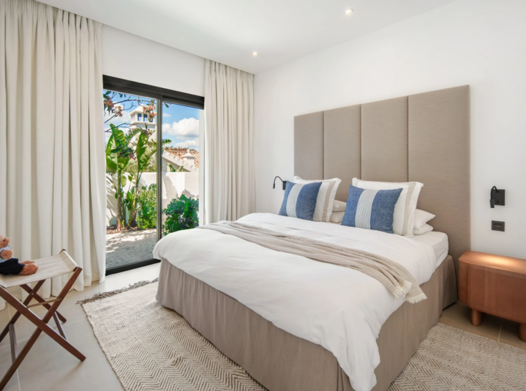 Guest bedroom with garden access and blue cushions