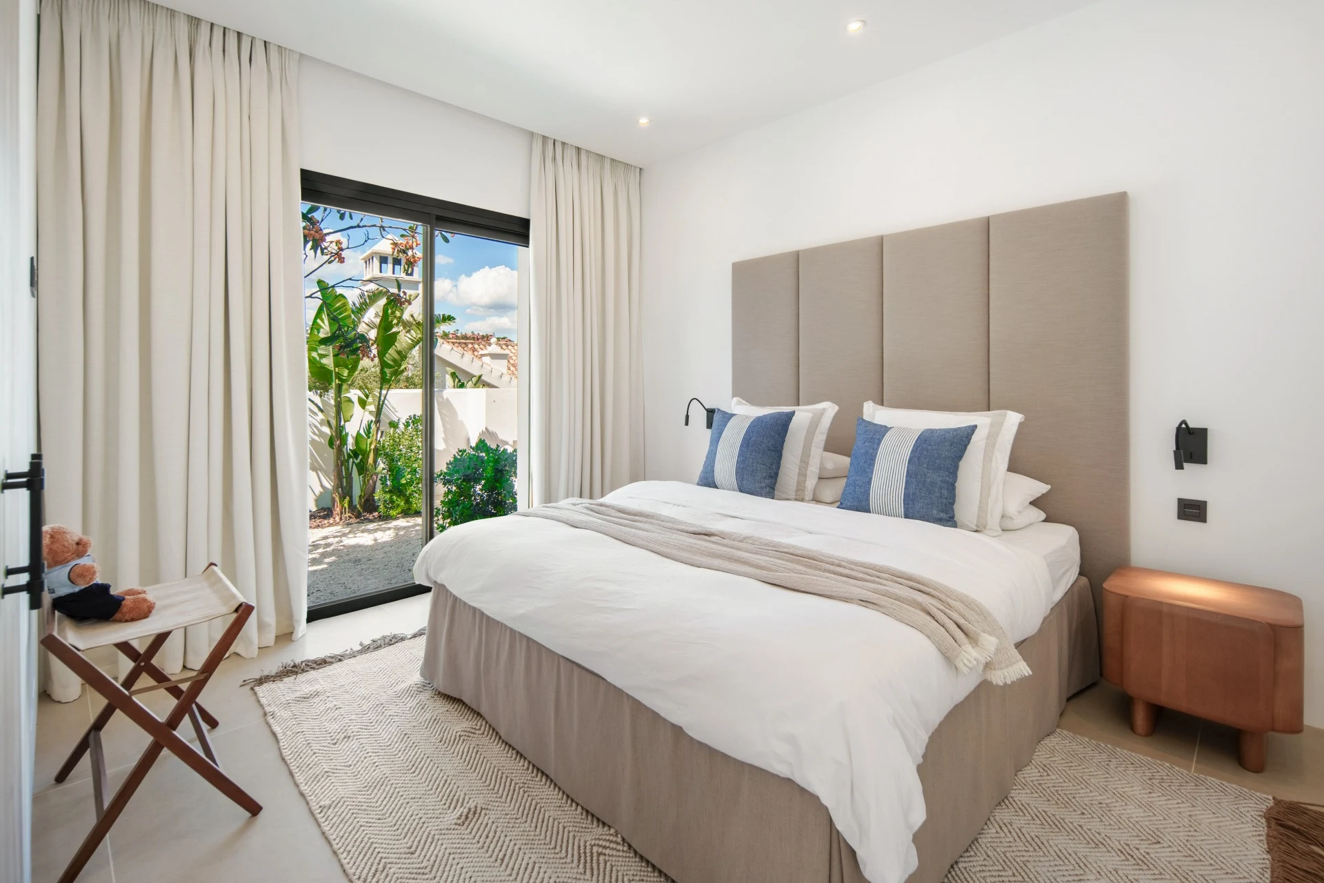 Guest bedroom with garden access and blue cushions