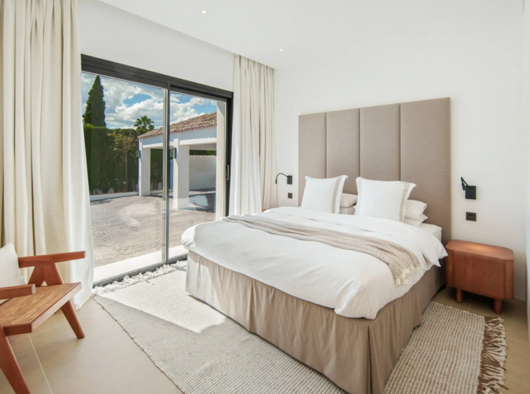 Guest bedroom opening towards a private outdoor area