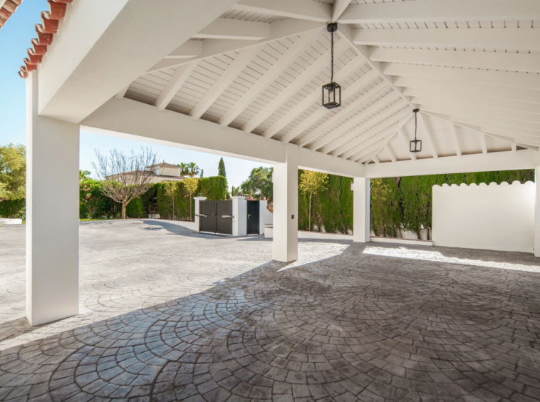 Covered parking area beside the private driveway
