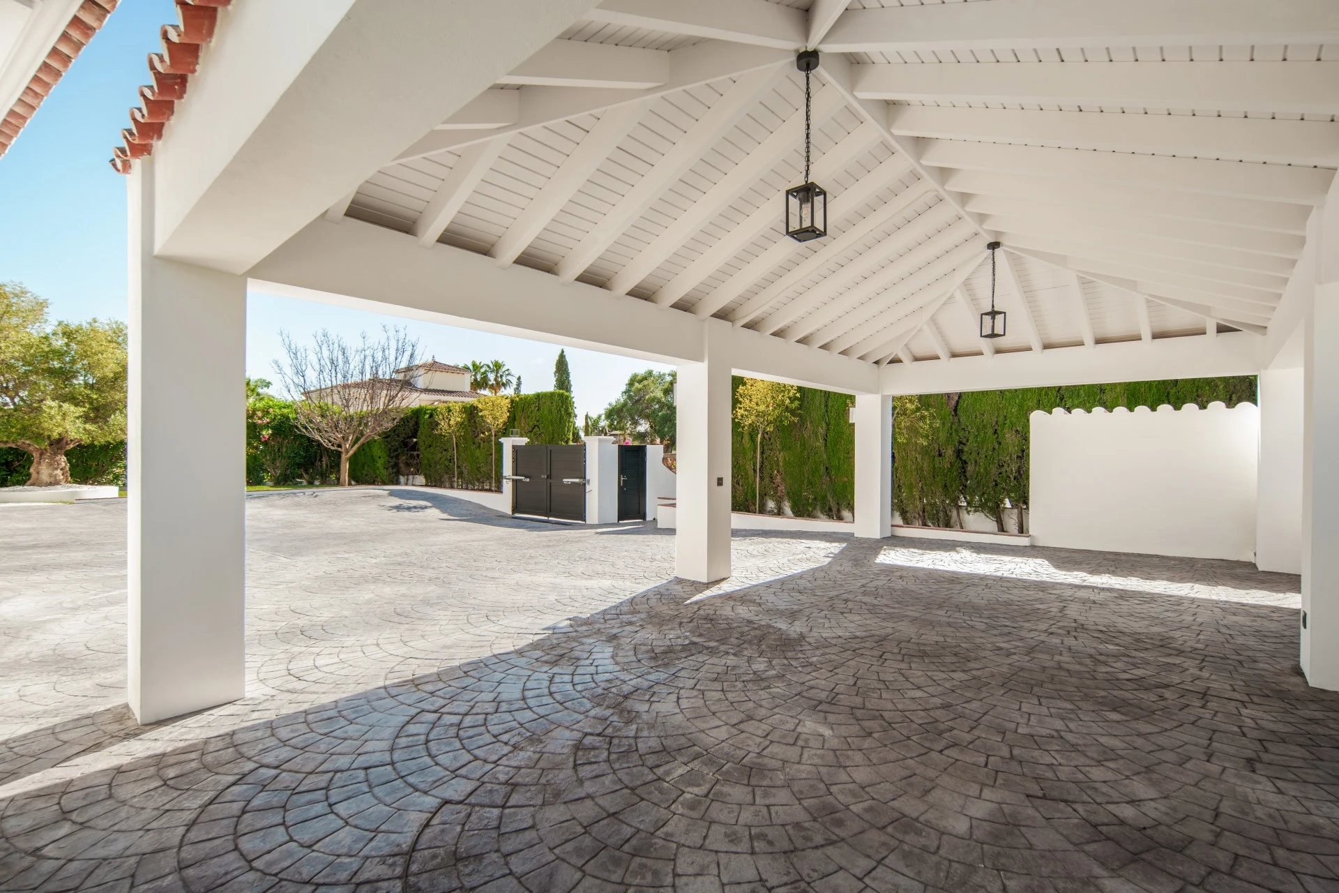 Covered parking area beside the private driveway