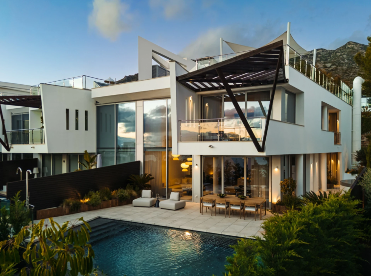 Contemporary facade and private pool at dusk