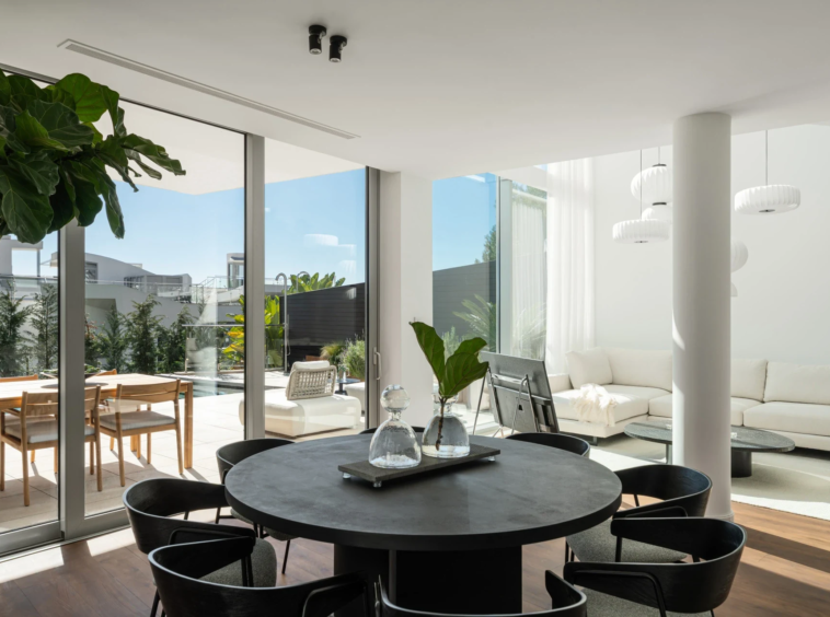 Open-plan dining area with pool terrace views