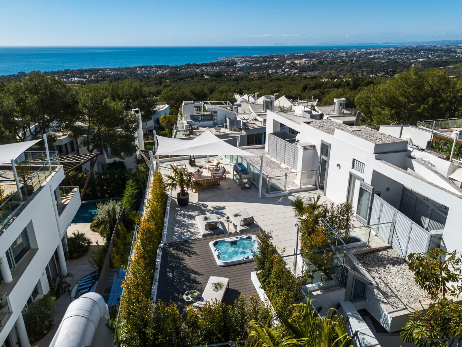 Elevated view across the rooftop terrace towards the coast