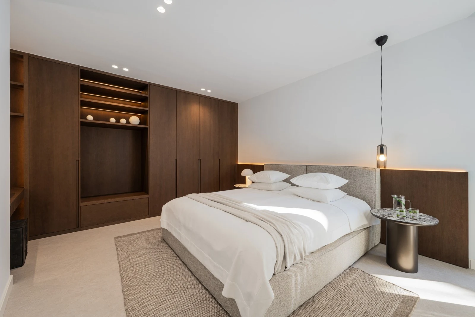 Bedroom with fitted headboard and warm lighting