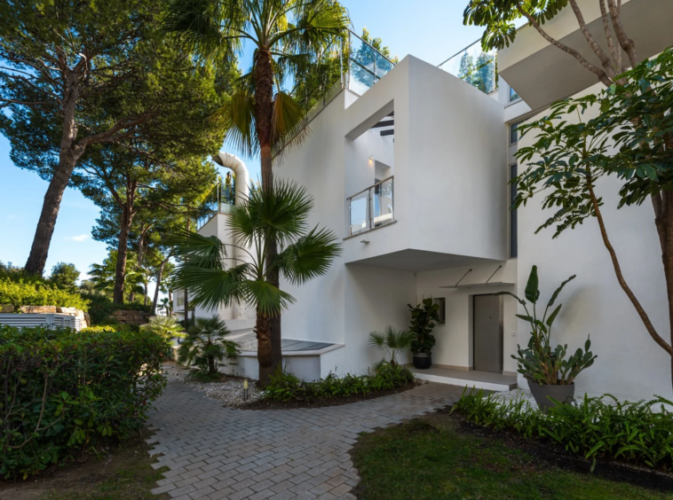 Exterior entrance surrounded by mature planting