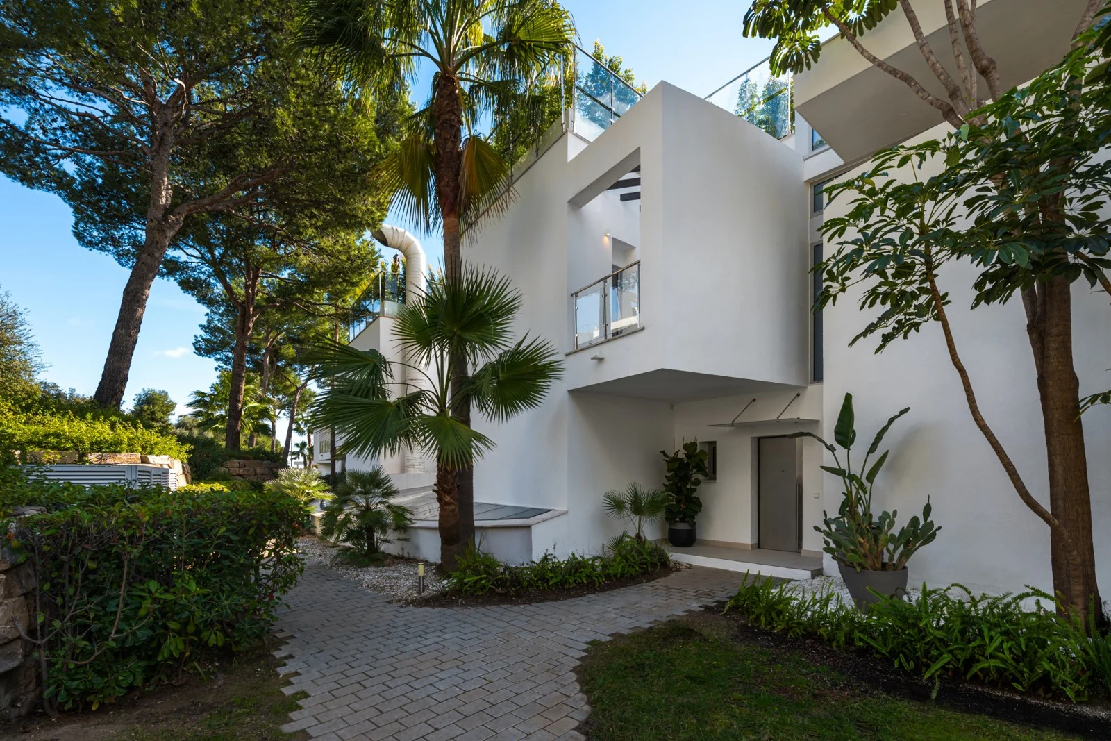 Exterior entrance surrounded by mature planting
