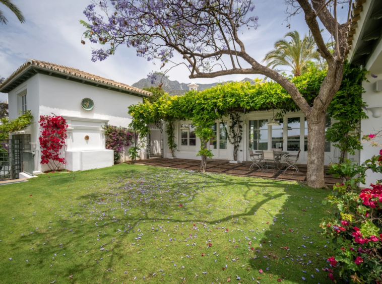 Mature lawn and Mediterranean villa exterior