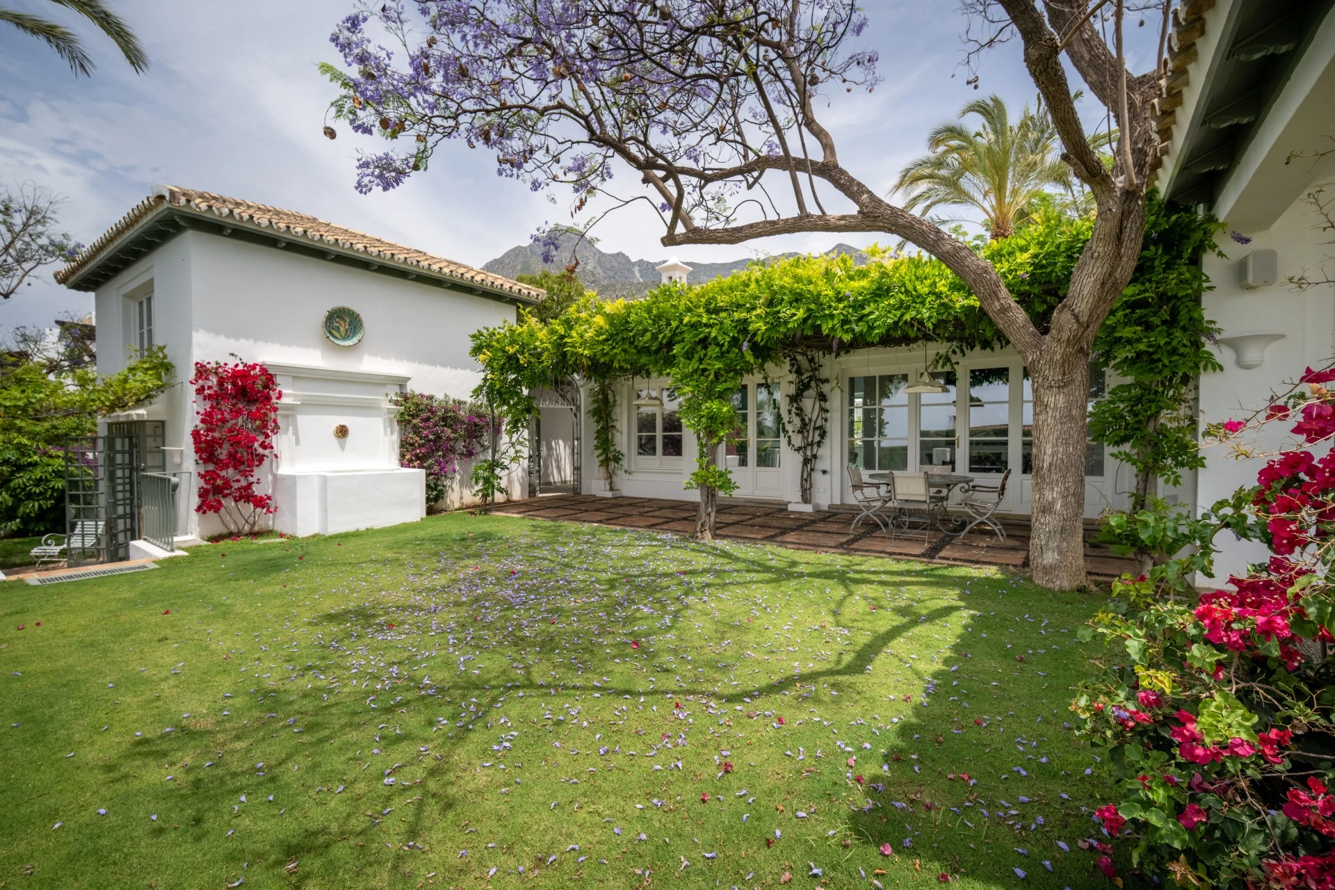 Mature lawn and Mediterranean villa exterior