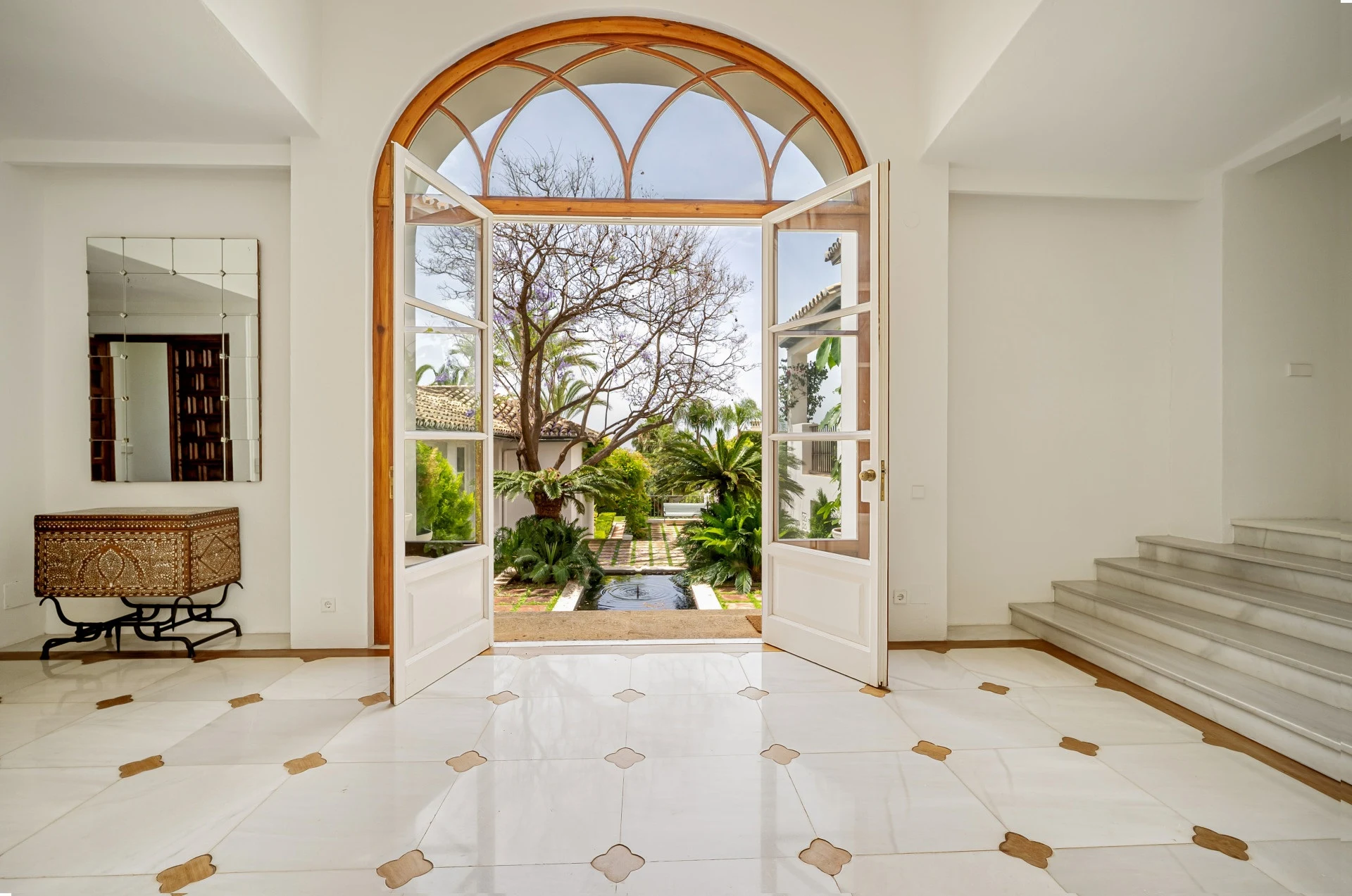 Arched entrance hall with garden views