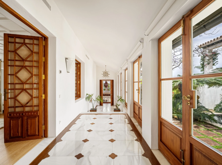 Light-filled corridor with wooden garden doors