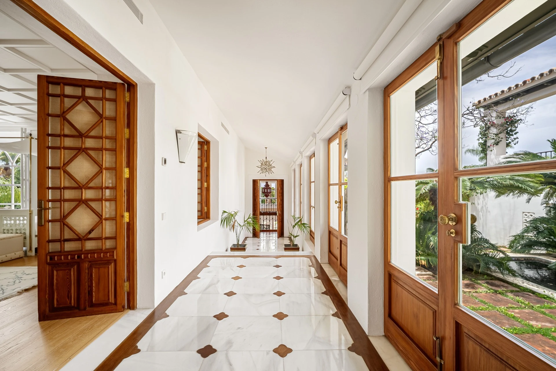 Light-filled corridor with wooden garden doors