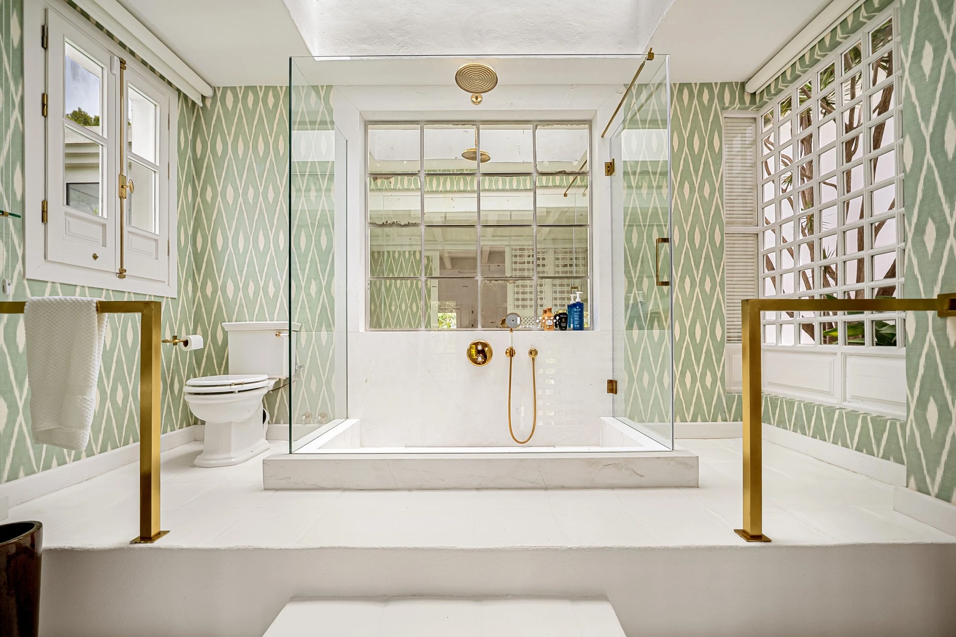 Bathroom with a freestanding bathtub and patterned tiles