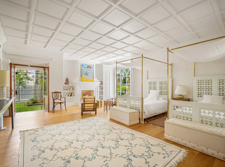 Spacious bedroom with vaulted ceiling and seating