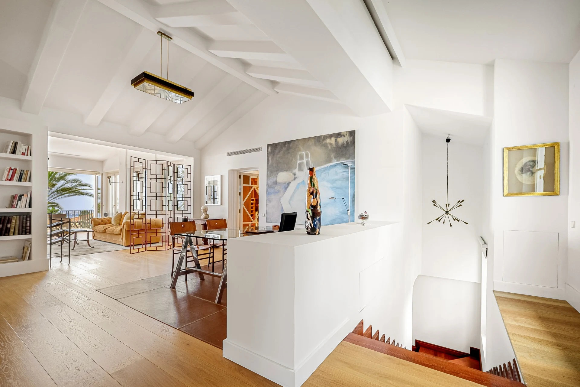 Home office with built-in shelves and high ceiling